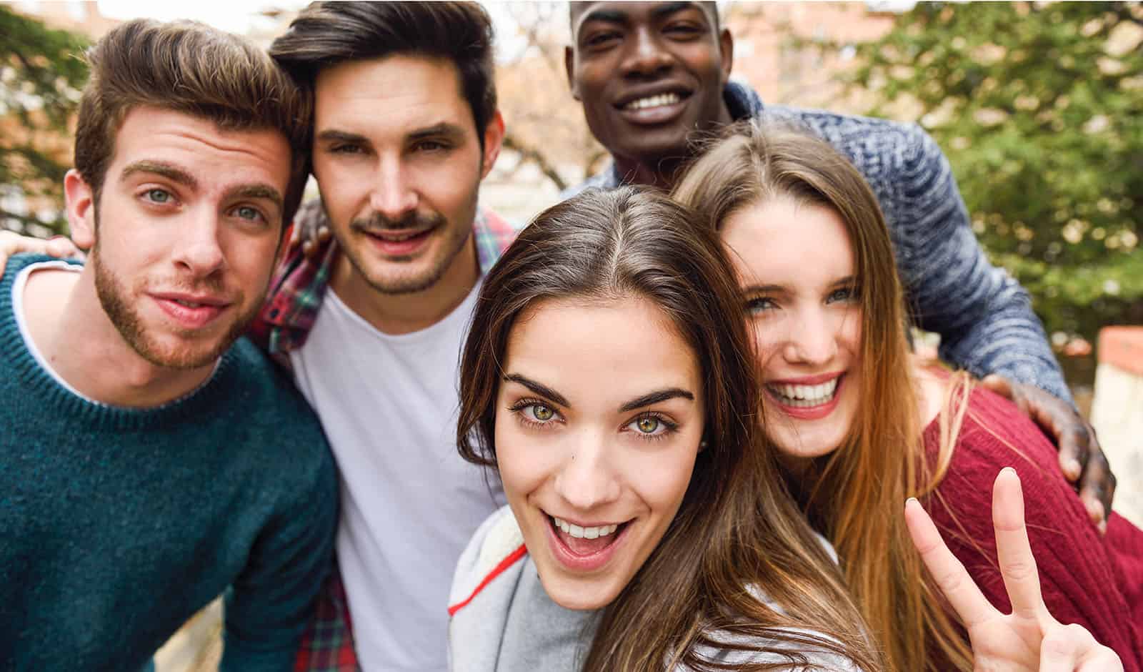 Group of multi-ethnic young people having fun together outdoors