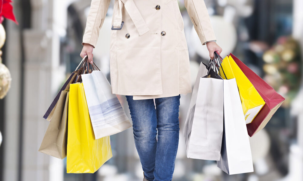 woman-in-a-coat-holding-shopping-bags