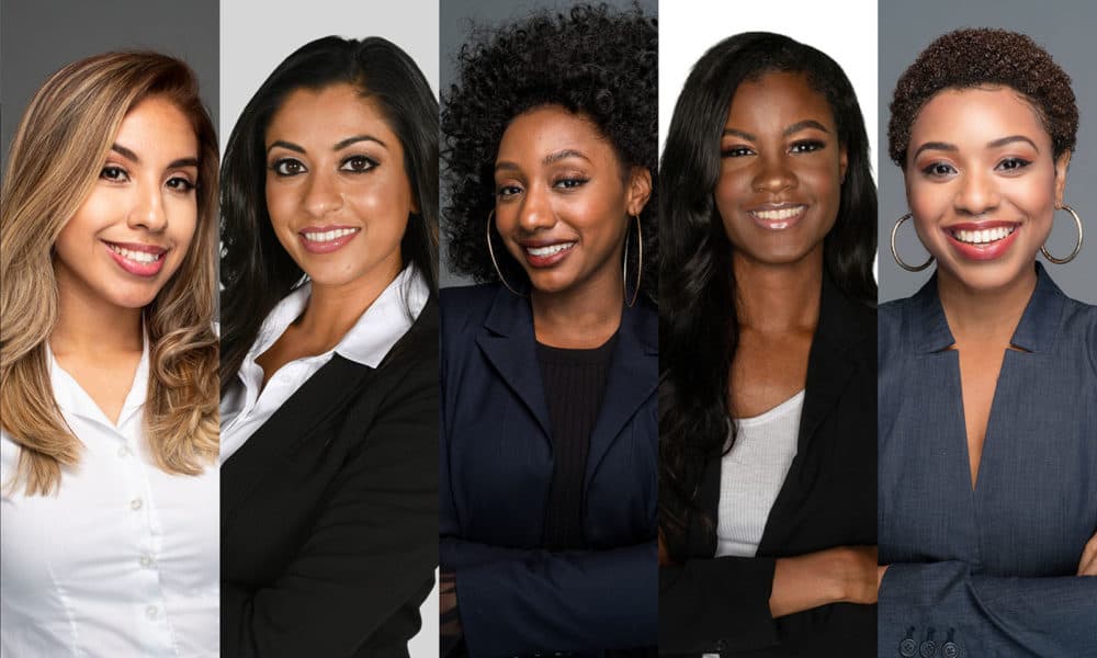 Group of six happy minority businesswomen at work