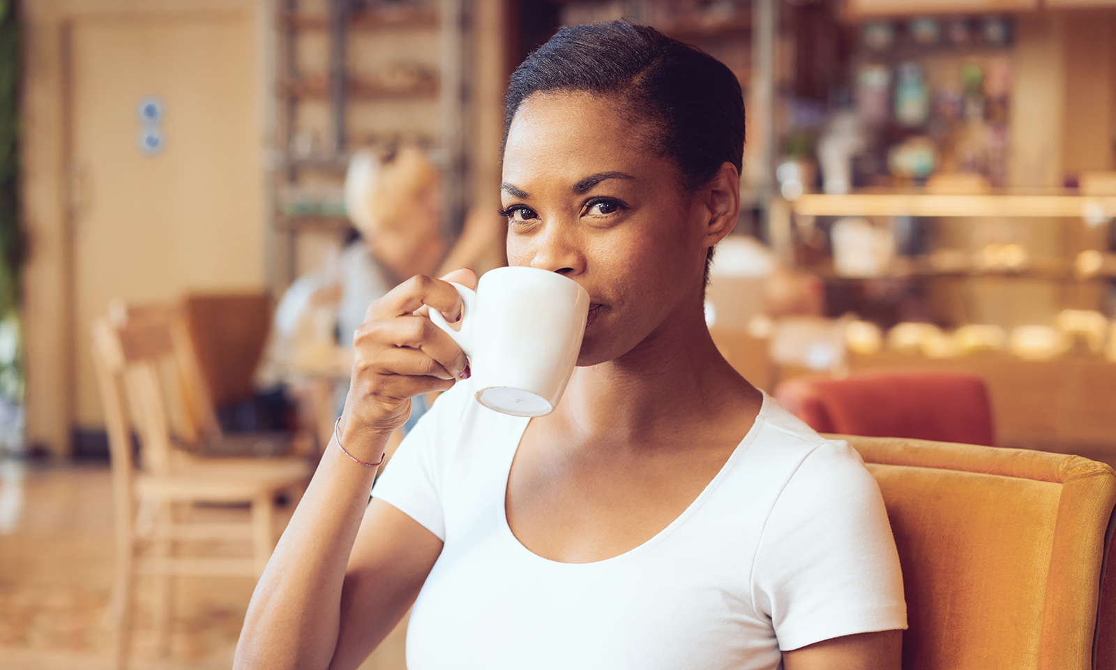 woman-smiling-and-drinking-coffee