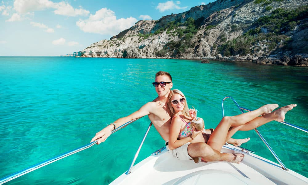 Couple resting on a yacht at sea. Luxury holiday vacation.