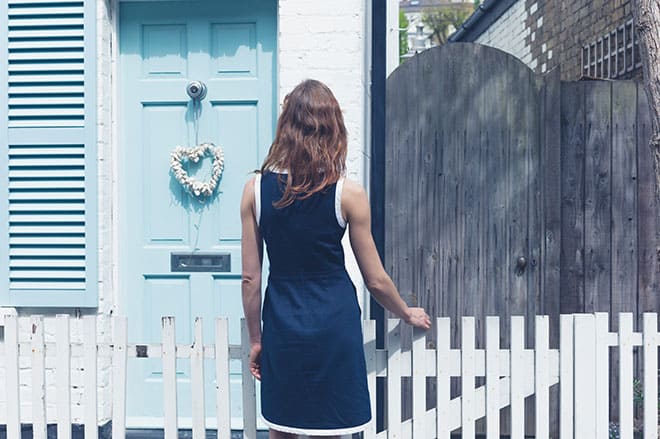 are-you-ready-to-buy-a-house-woman-staring-at-small-blue-home