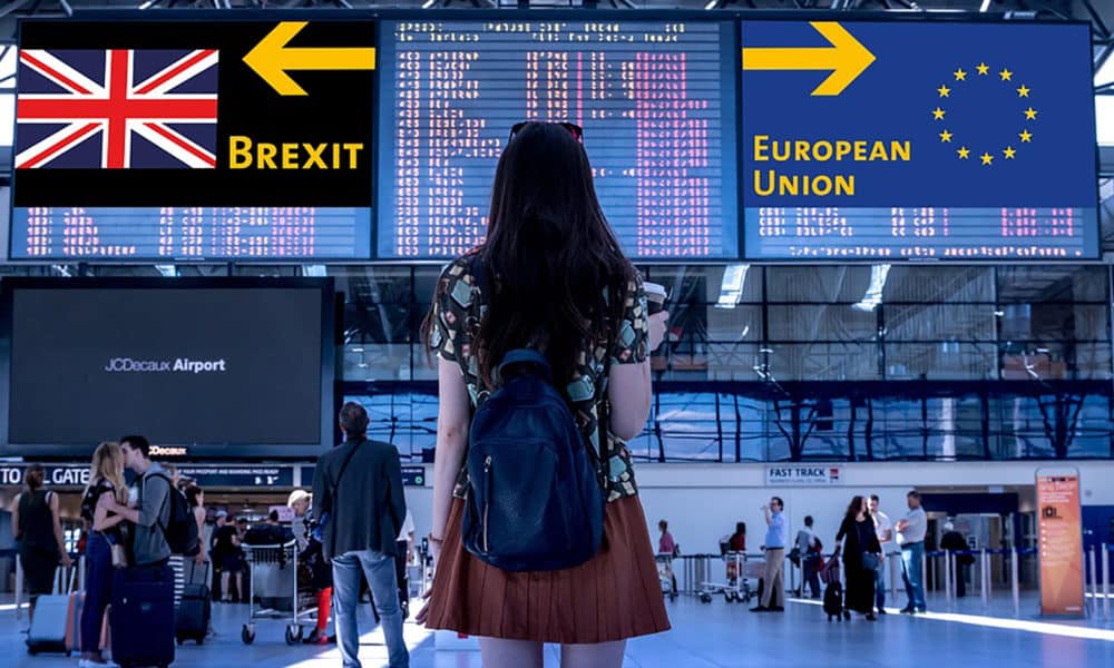 woman standing at the airport loloking at the brexit