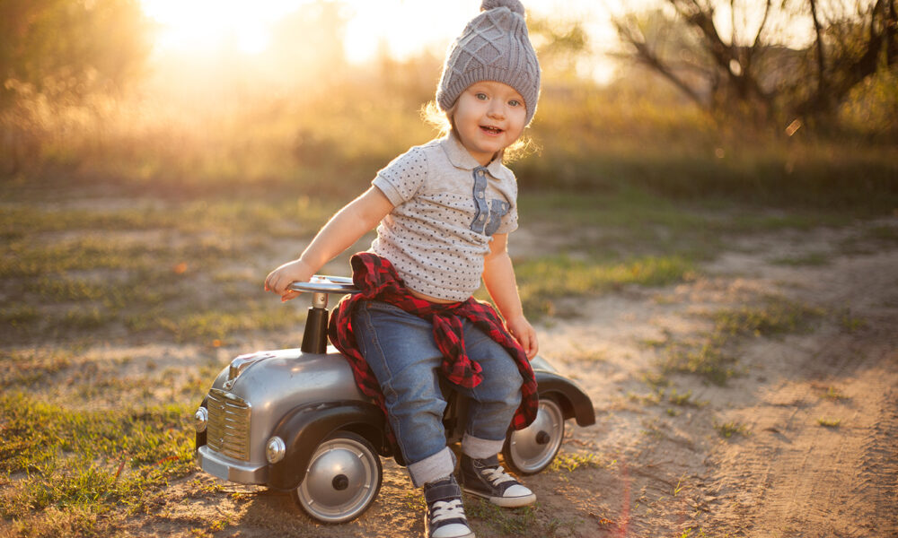 child-sitting-on-toy-bike