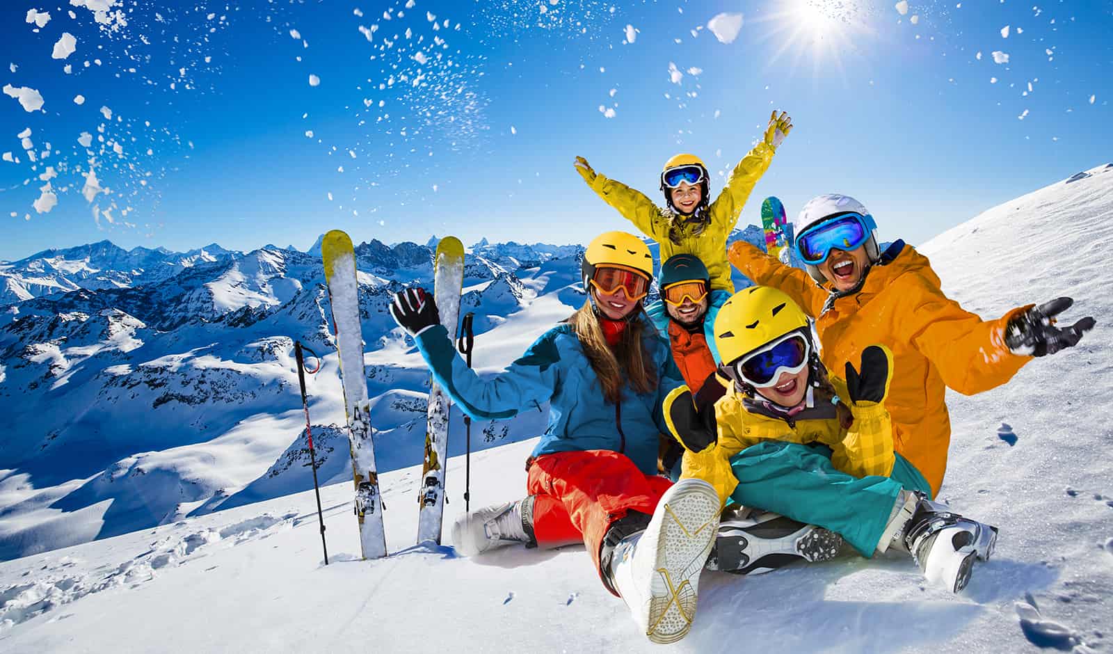 Happy family enjoying winter vacations in mountains. Playing with snow, Sun in high mountains. Winter holidays.