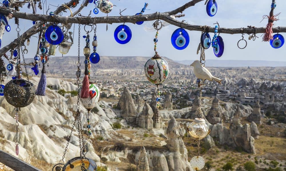 evil-eye-necklaces-hanging-from-tree-in-desert