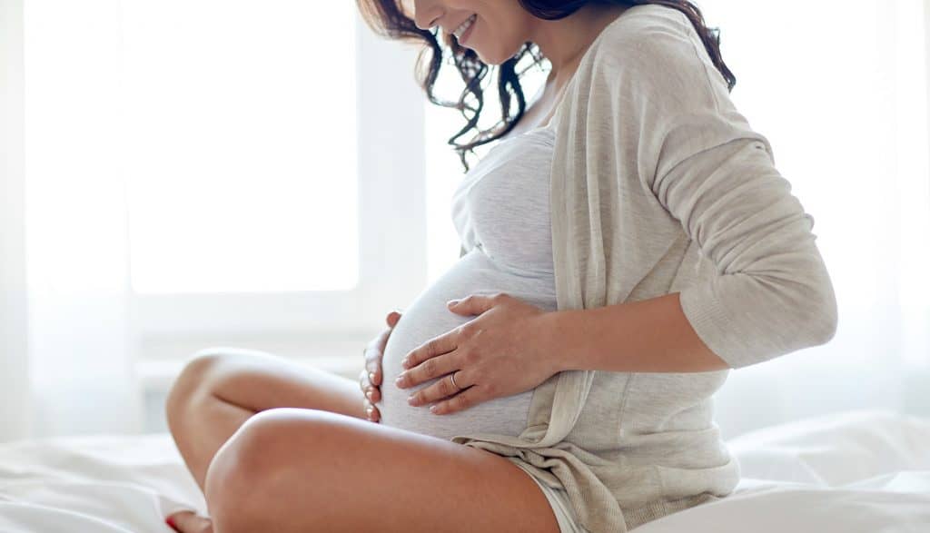 motherly-instinct-pregnant-women-holding-her-belly