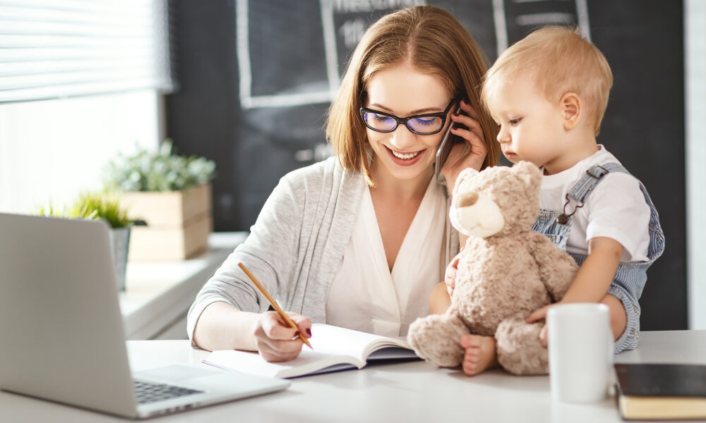 Businesswoman mother woman with a toddler working