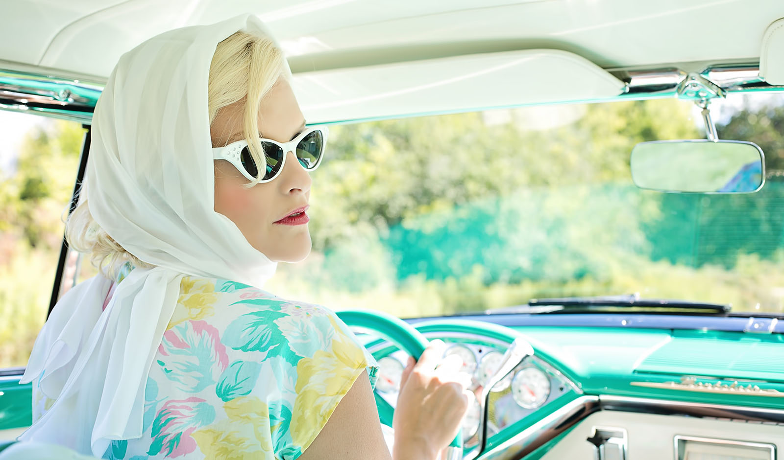 1960s classic car with beautiful blonde woman