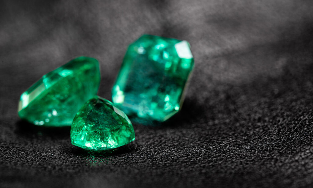 5-facts-about-emeralds-people-dont-know-three-emeralds-on-black-background