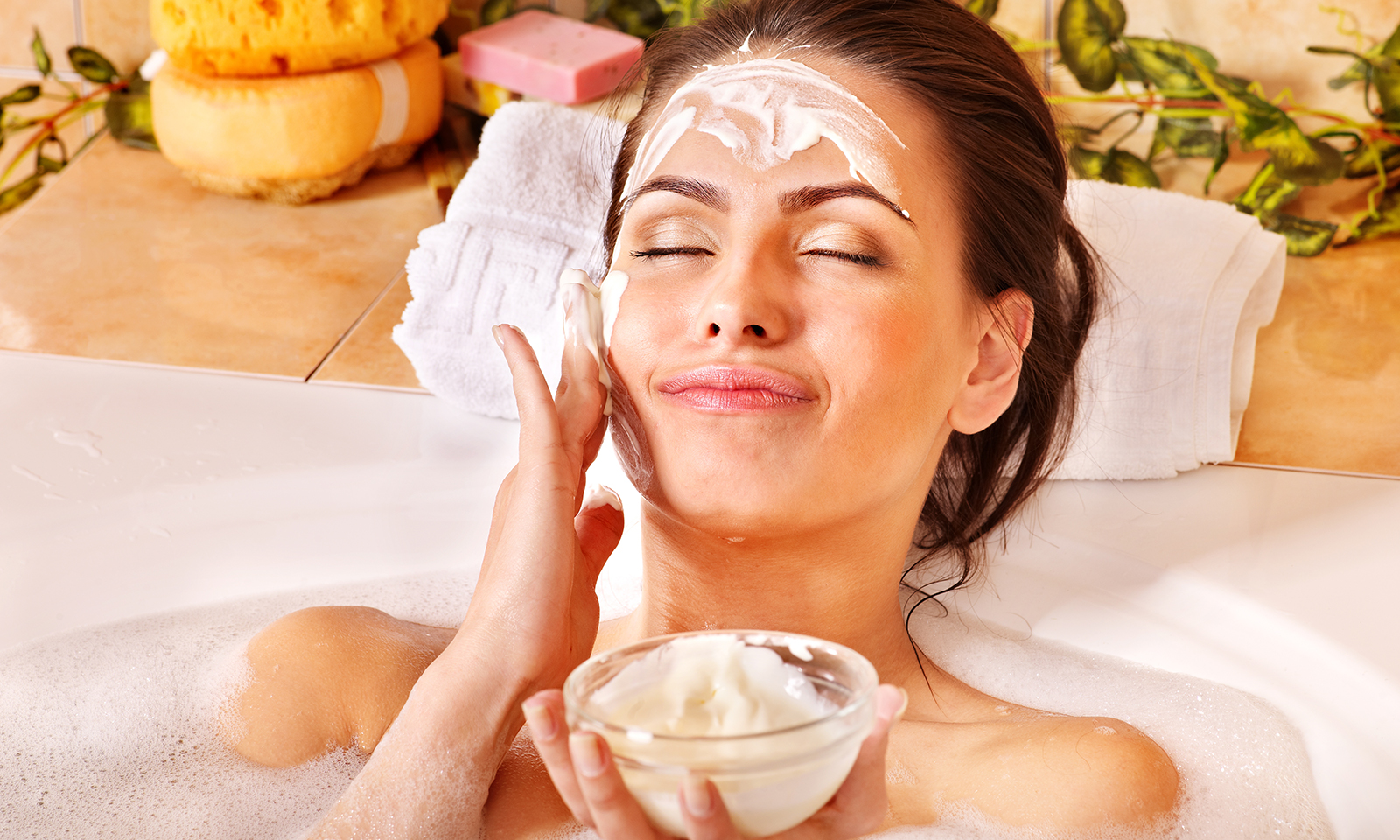 at-home-beauty-treatment-spa-day-woman-applying-mask-in-tub