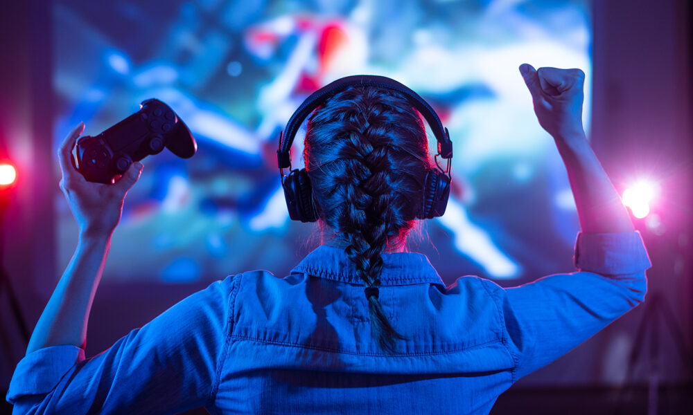 girl-gamer-playing-on-computer-celebrating-win