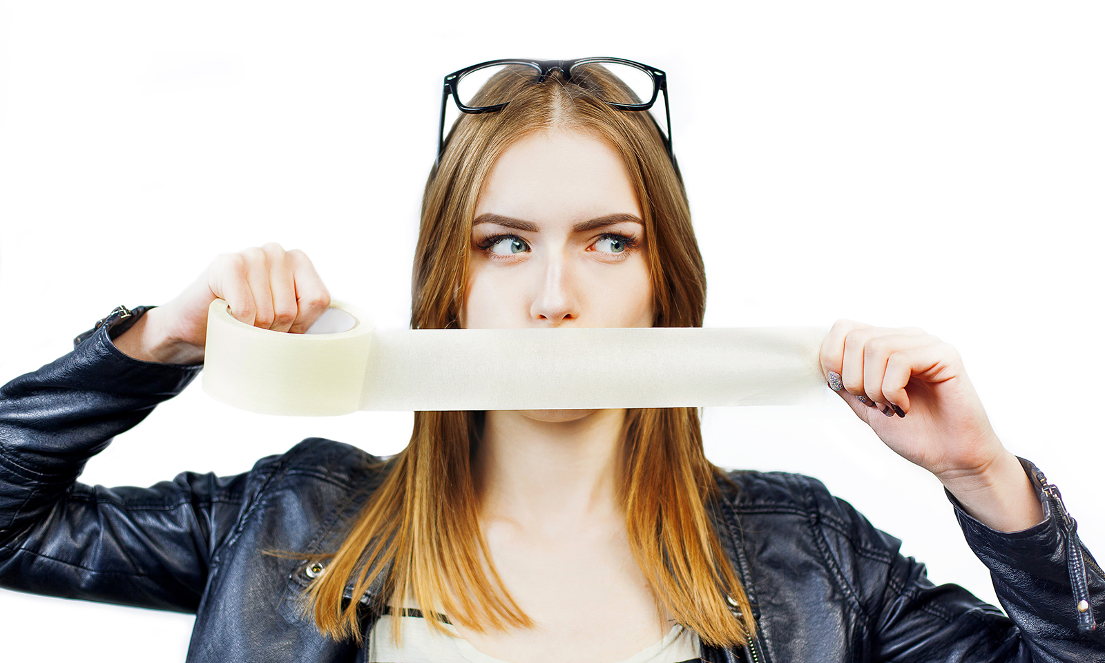 should-you-try-mouth-taping-woman-holding-tape-up-to-mouth-main